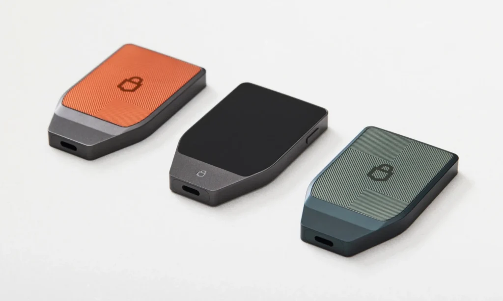 Three cryptocurrency hardware wallets displayed.